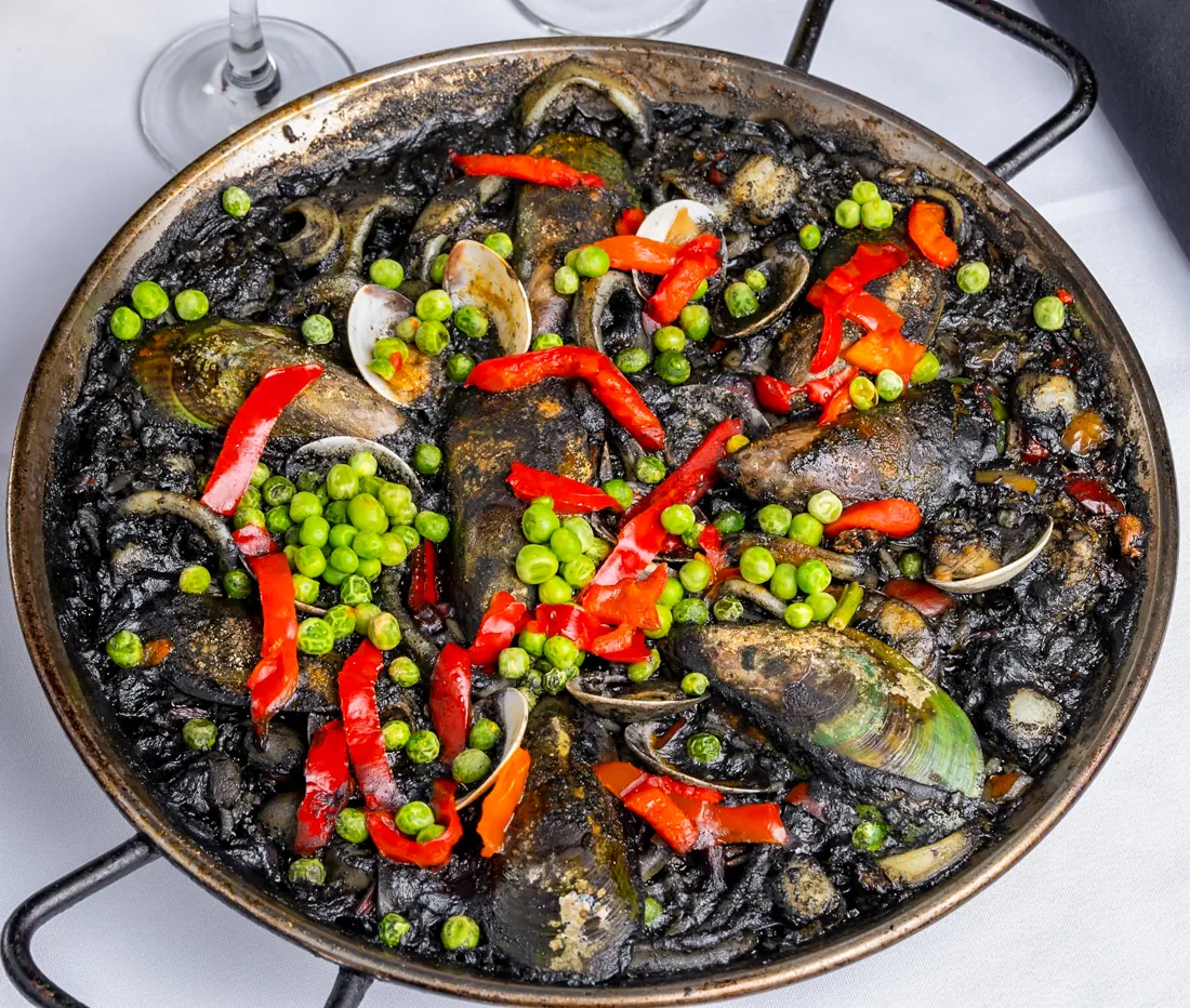 Paella negra — black rice cooked in squid ink with seafood at Los Gallegos Miami